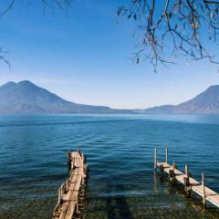 shutterstock_210754834 Wooden footbridges on the lake Atitlan in Guatemala with volcanoes on the background.jpg
